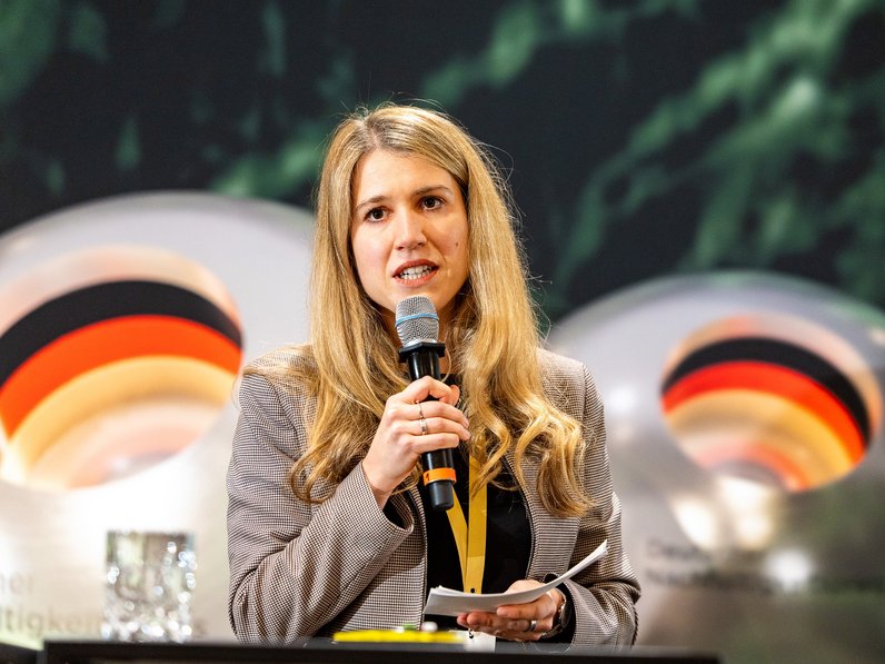 Marion Jäger speeking to the DNP Audience about AlmaWin's Sustainability